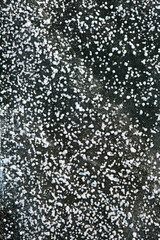 The pattern on the ice from the pieces of snow