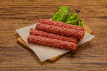 Raw beef sausages with spices