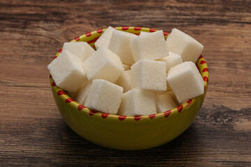 Refined white sugar cubs in the bowl