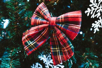 Snowflakes and red bows on the Christmas tree