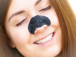 Woman with nose mask pore strips