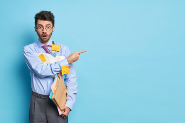 Emotional shocked unshaven male entrepreneur stares bugged eyes at camera gives presentation of...