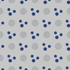 Gray and blue geometric pattern of small and large circles. Dark blue and gray circles on a gray background.