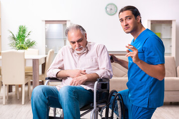 Old man in wheel-chair and young bad caregiver indoors