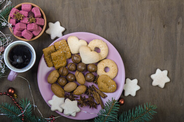 Cookies in a pink saucer, sugar in a wooden bowl and a cup of coffee.