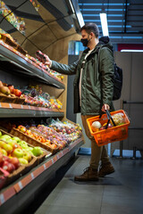 man buying fruits at groceries store