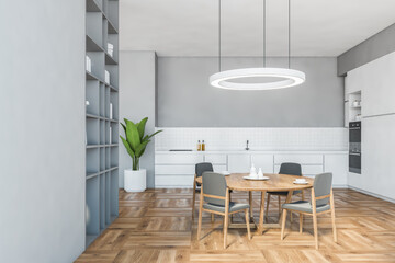 Grey dining room with beige chairs and white kitchen set on parquet floor