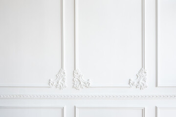 white wall decorated with stucco in the form of decorative curls