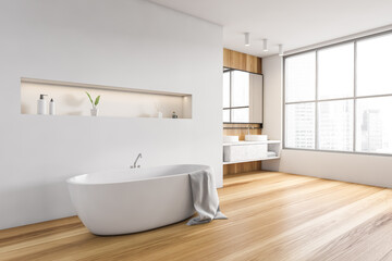 White and wooden bathroom with white bathtub, mirror and big window