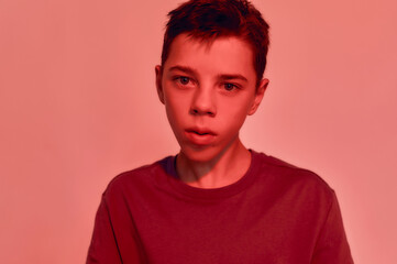 Close up portrait of teenaged disabled boy with cerebral palsy looking at camera, posing isolated...
