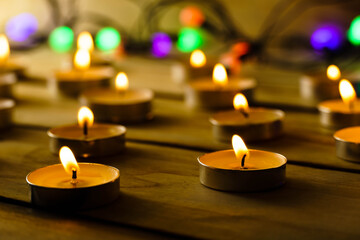 Many burning candles and colorful lanterns on a wooden , shot with shallow depth of field