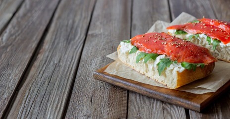 Open sandwiches with salmon, arugula and white cheese. Healthy eating.