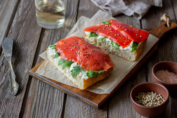 Open sandwiches with salmon, arugula and white cheese. Healthy eating.