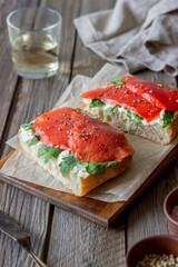 Open sandwiches with salmon, arugula and white cheese. Healthy eating.