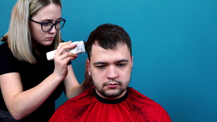 Time lapse shooting. A woman cuts a man's hair at home, in a salon, in fast motion