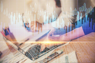 Multi exposure of woman hands typing on computer and financial chart hologram drawing. Stock market...