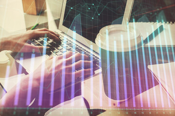 Double exposure of woman hands typing on computer and forex chart hologram drawing. Stock market...