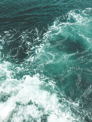 Fototapeta na wymiar Blue water with foam waves. Deep sea. Peaceful ocean. Abstract natural background.