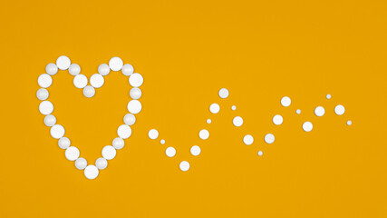 White Pills in form of heart and heart rhythms on yellow background Flat lay.