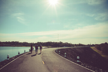 Paved Walkway path on top of earthen dike levee along. In Thailand.