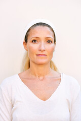 Close up portrait of mature woman wearing white clothes