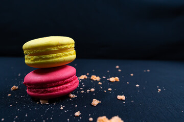 Colourful stack of macaroons isolated on plain black background. Copyspace