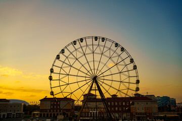 Ferris wheel against a sunset sky. entertainment for tourists.