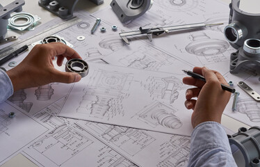Engineer technician designing drawings mechanical parts engineering Engine.manufacturing factory...