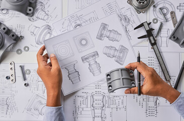 Engineer technician designing drawings mechanical parts engineering Engine.manufacturing factory...