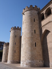 Fototapeta na wymiar Walls of palace in european Saragossa city at Aragon district in Spain, clear blue sky in 2019 warm sunny summer day on September - vertical.