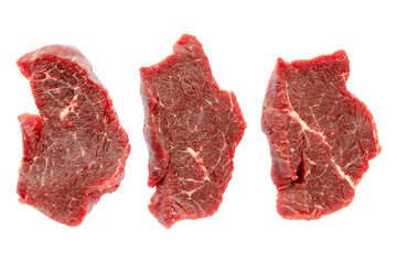 Three pieces of beef meat isolated on white background, clipping path, top view. Pieces of buffalo meat close-up, top view. Pieces of beef for steak. Fresh raw cuts of beef. Fresh beef slices.