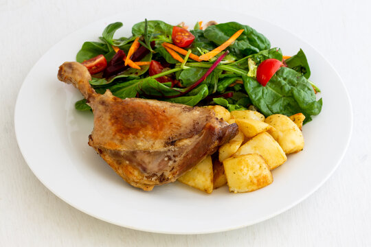 Duck leg confit with salad and potatoes