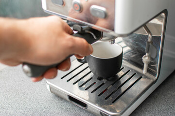 Fototapeta na wymiar Preparing freshly ground espresso in a coffee machine