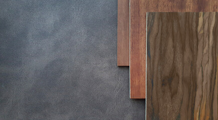combination of interior material between set of red brown tone wooden veneer containing hickory ,oak ,cherry wood texture placed on dark brown leather fabric (focused on leather texture).