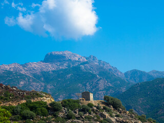 Fototapeta na wymiar Abandoned house on the hill. Mountain view as a background. Near the capital city, Ajaccio, Corsica