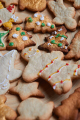 Gingerbread man cookie close up. The concept of a feast in the house, a family dinner. New Year traditions concept and cooking process. Cookies on dark brown wooden table. Family making