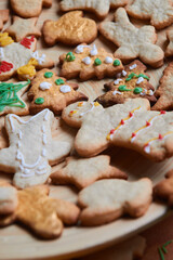 Gingerbread man cookie close up. The concept of a feast in the house, a family dinner. New Year traditions concept and cooking process. Cookies on dark brown wooden table. Family making