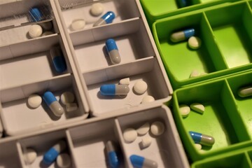Close up of different pills prepared in tablets boxes