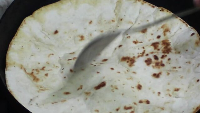 Making roti chapati naan paratha by spreading the dough with hand