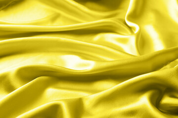 Draped silk fabric in trendy lighting yellow in 2021. Abstract modern background