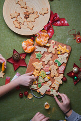 Making angry gingerbread man, cookie dough. The concept of a feast in the house, a family dinner. New Year traditions concept and cooking process. Cookies on dark brown wooden table. 