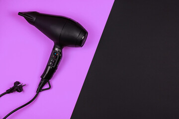 Personal care concept, hair dryer with plug on a simple saturated background with space for text, copy space, flat lay