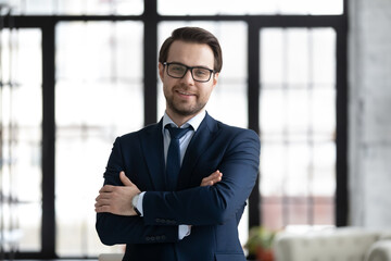 Head shot portrait smiling confident businessman wearing suit and glasses looking at camera,...