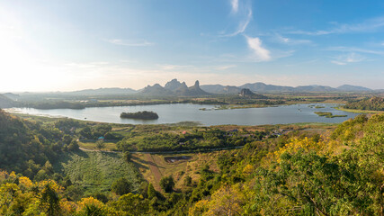Panorama of  landscape with dramatic sunset and steep mountain ridge on horizon.  Thailand