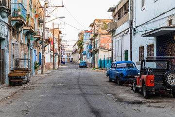 Havana Cuba Classic Cars. Typcal Havana urban scene with colorful buildings and old cars. Sunset...