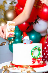 Sliced Christmas cake. In hand a spatula with a piece of cake. Inscription Good Christmas.
Concept of how to serve a cake, congratulations on the holiday
Concept of how to serve a cake, congratulation