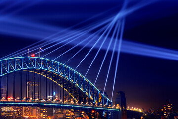 Sydney Harbour Bridge at night close up of lights beaming from the top of the bridge for Vivid Festival. 