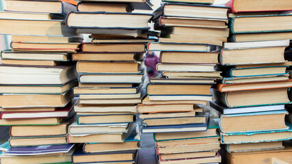 Obraz premium Piles of used books on flea market bookshop.