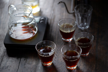 Coffee drip on the table, ground coffee beans contained in a filter. Breakfast concept.