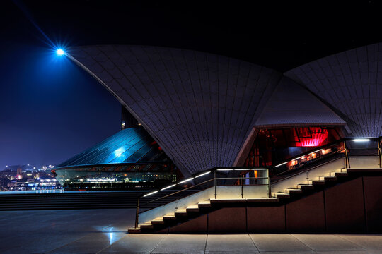 SYDNEY, AUSTRALIA - JUNE 09 2019: Colourful Lights In The Opera House, Side Profile View With Steps Leading To The Top.